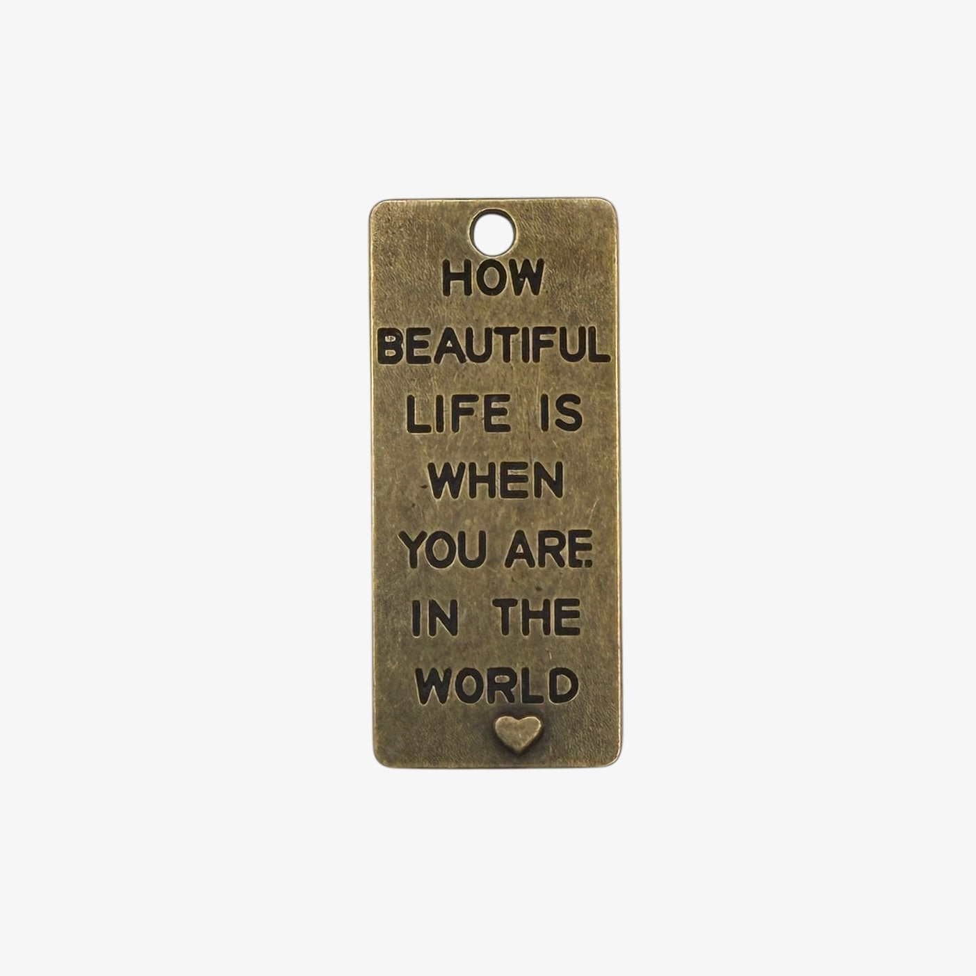 Bronze tag with motivational quote on a white background