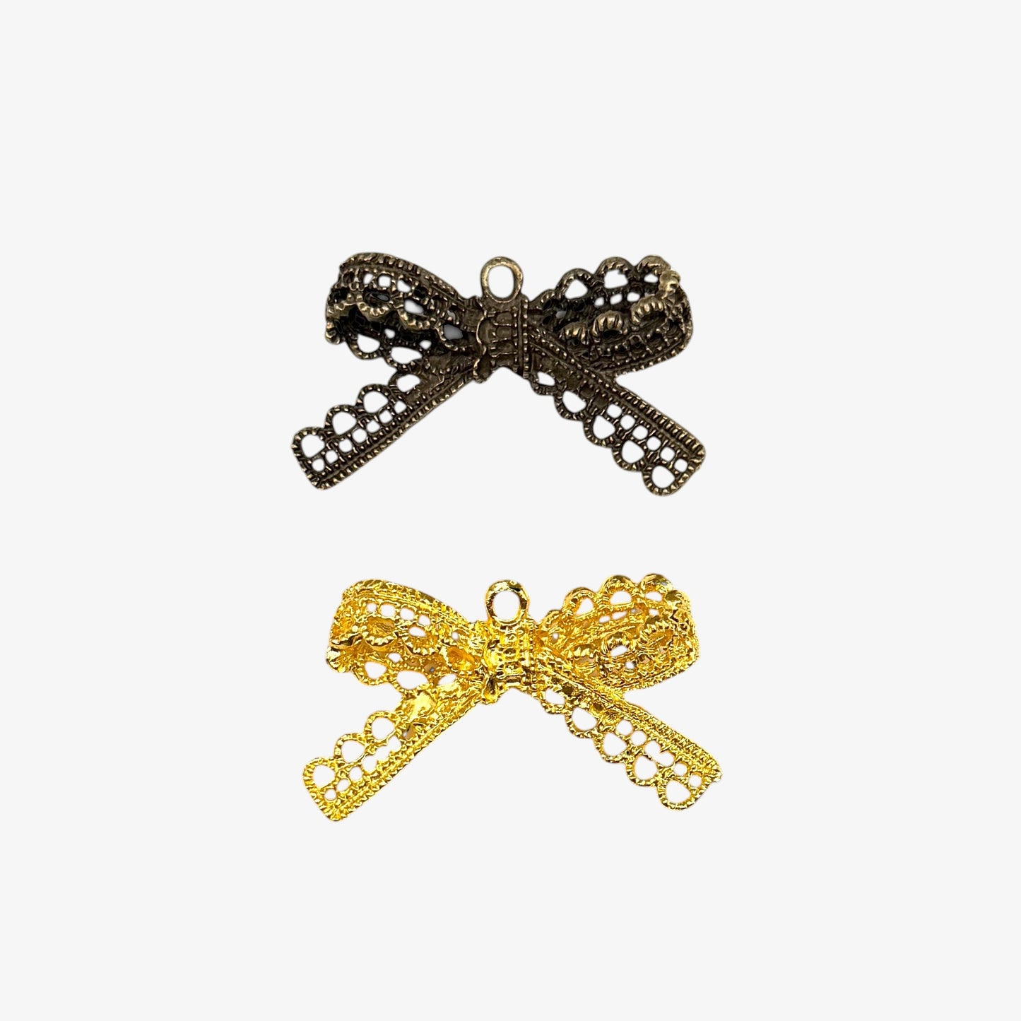 Bronze and gold bow-shaped pendants on a white background