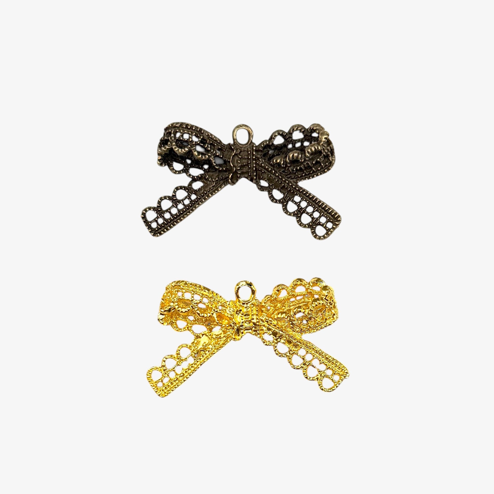 Bronze and gold bow-shaped pendants on a white background