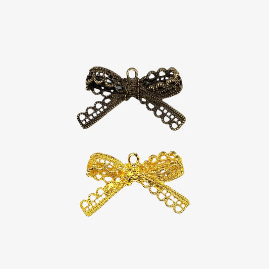 Bronze and gold bow-shaped pendants on a white background