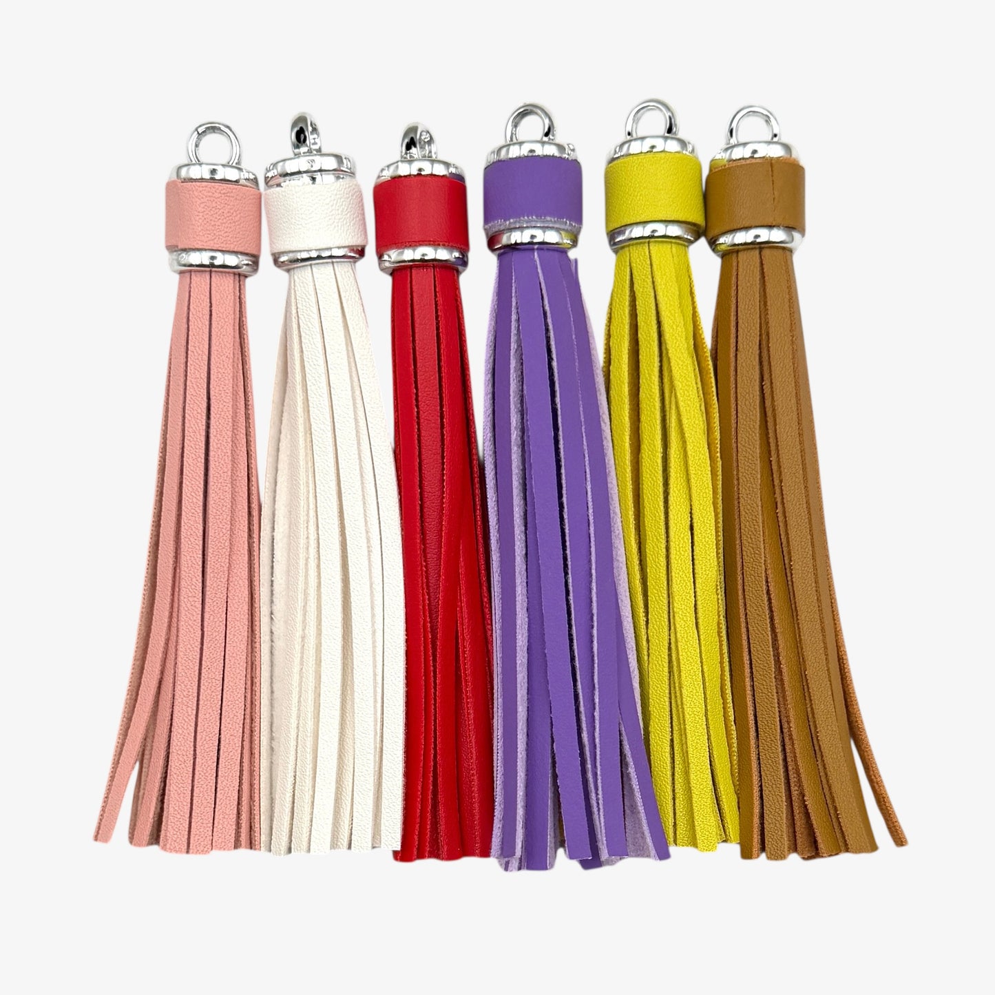 Set of five colorful tassels on a white background