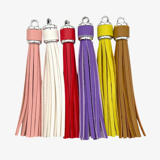 Set of five colorful tassels on a white background