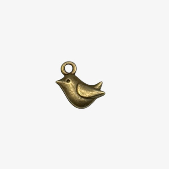 Bronze bird-shaped charm on a white background