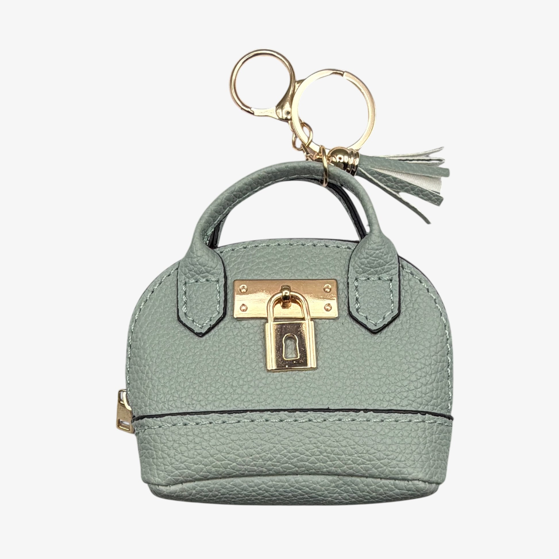 Mint green handbag-shaped keychain with gold accents on a white background