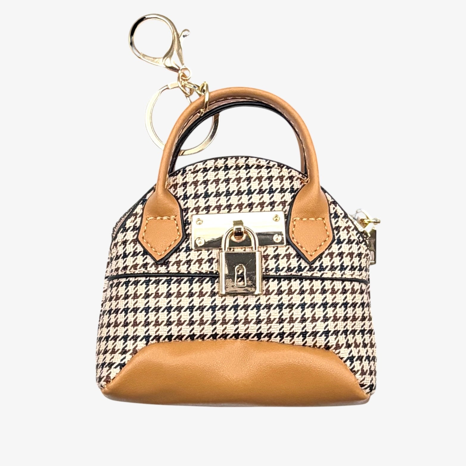 Miniature houndstooth patterned handbag with tan accents on a white background