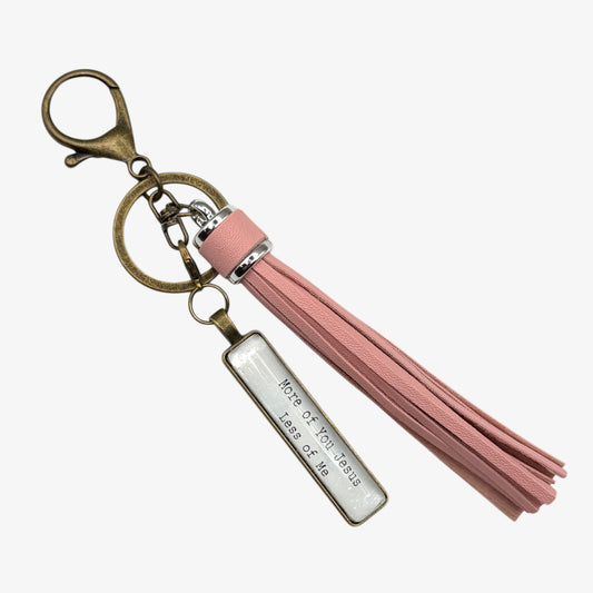 Keychain with pink tassel and engraved tag on a white background