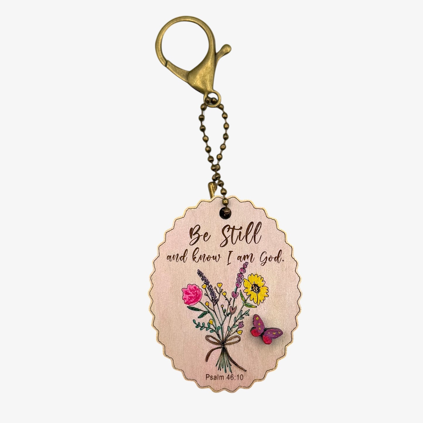 Keychain with floral design and motivational quote on a white background