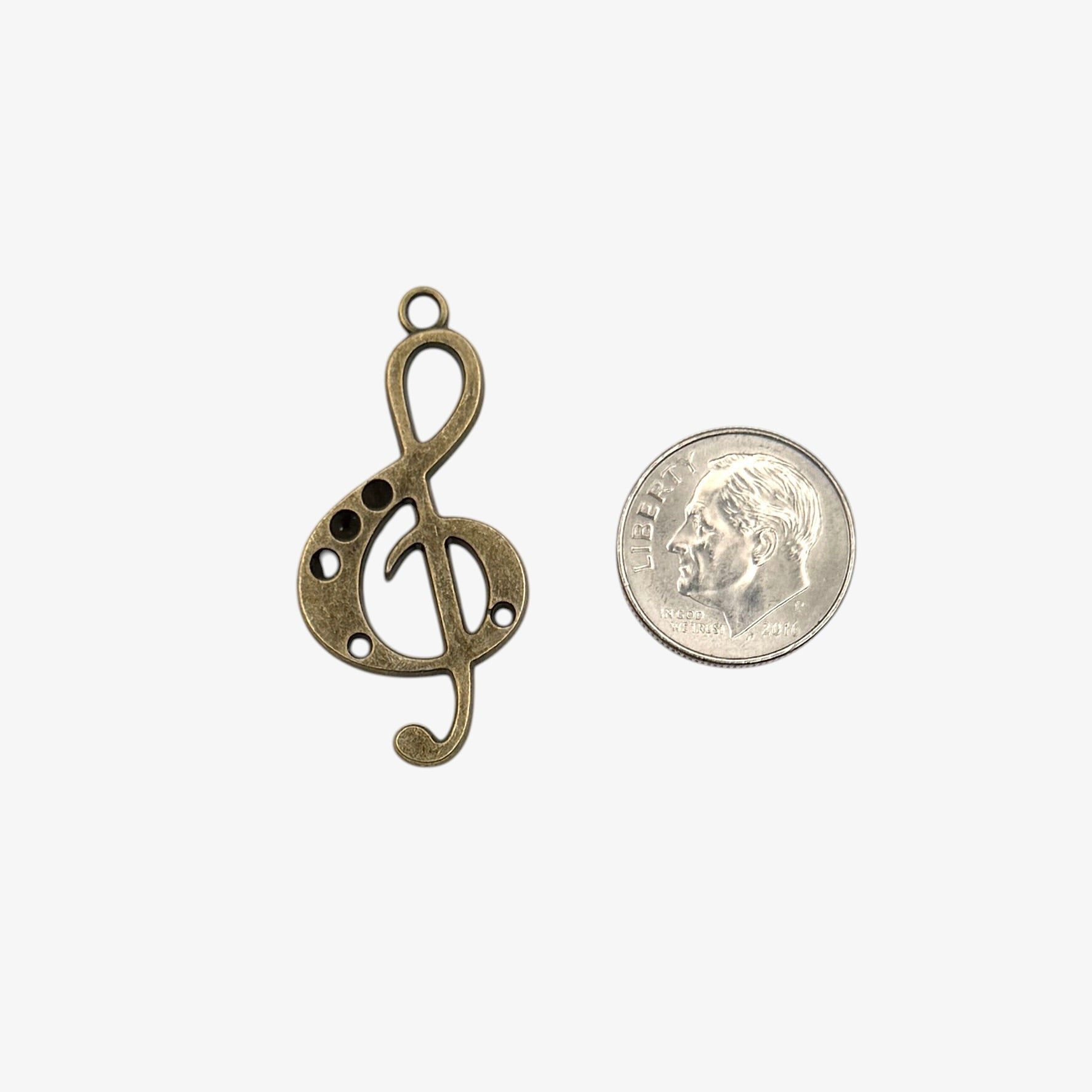 Bronze treble clef pendant on a white background