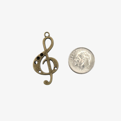 Bronze treble clef pendant on a white background