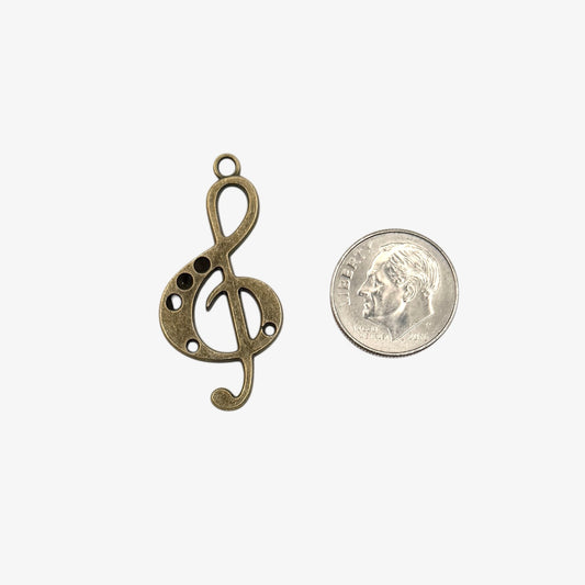 Bronze treble clef pendant on a white background