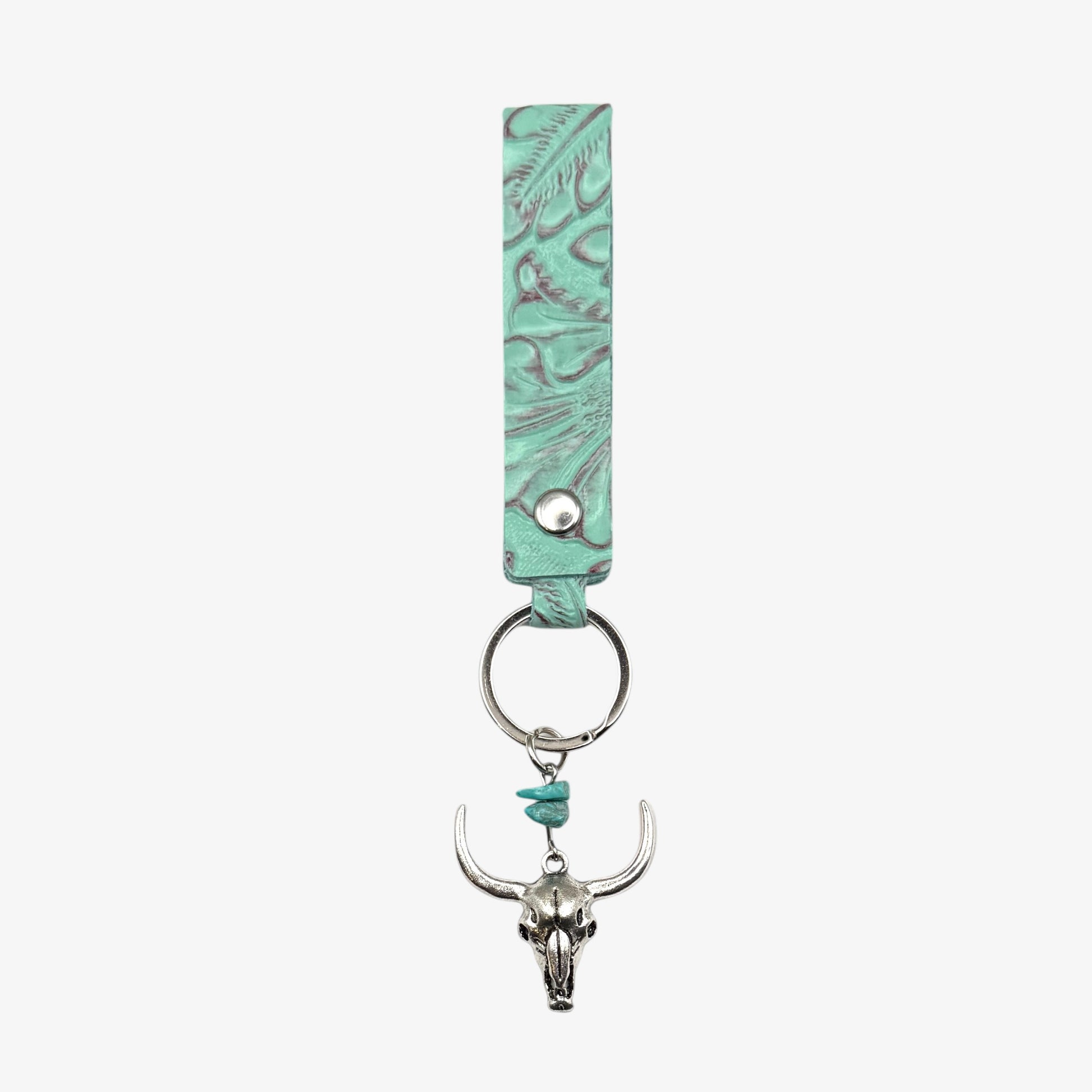 Turquoise leather keychain with bull skull charm on a white background