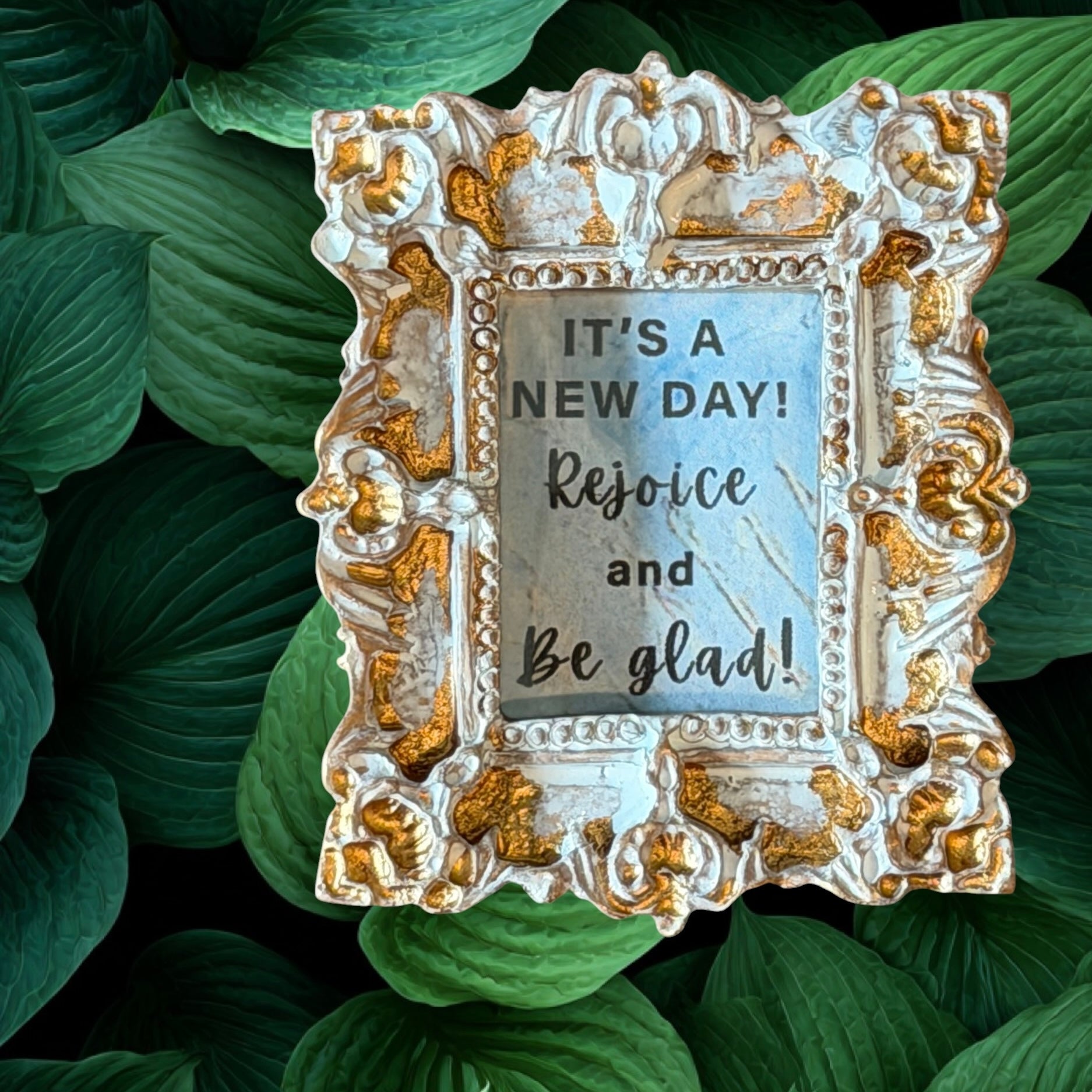 Decorative frame with motivational quote on green leaves