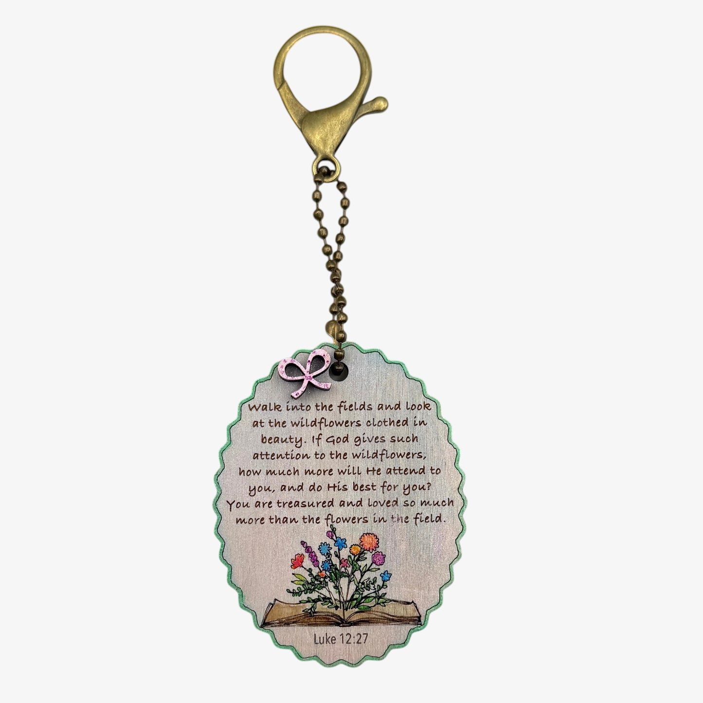 Keychain with motivational quote and floral design on a white background