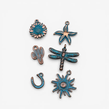 Set of copper and blue enamel charms on a white background