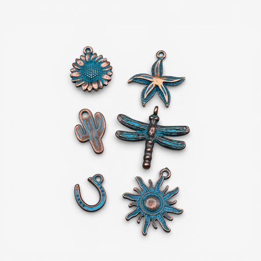 Set of copper and blue enamel charms on a white background