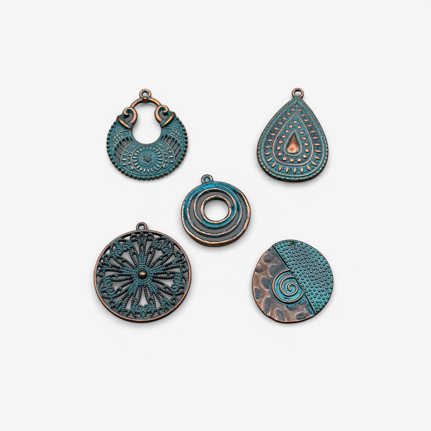Set of five decorative metal pendants on a white background