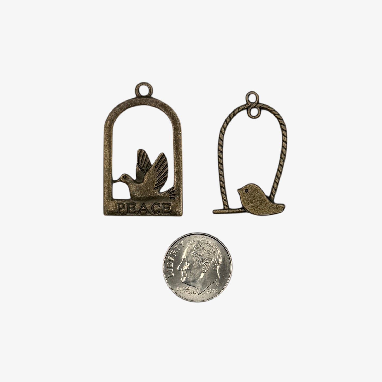 Two bronze bird charms 