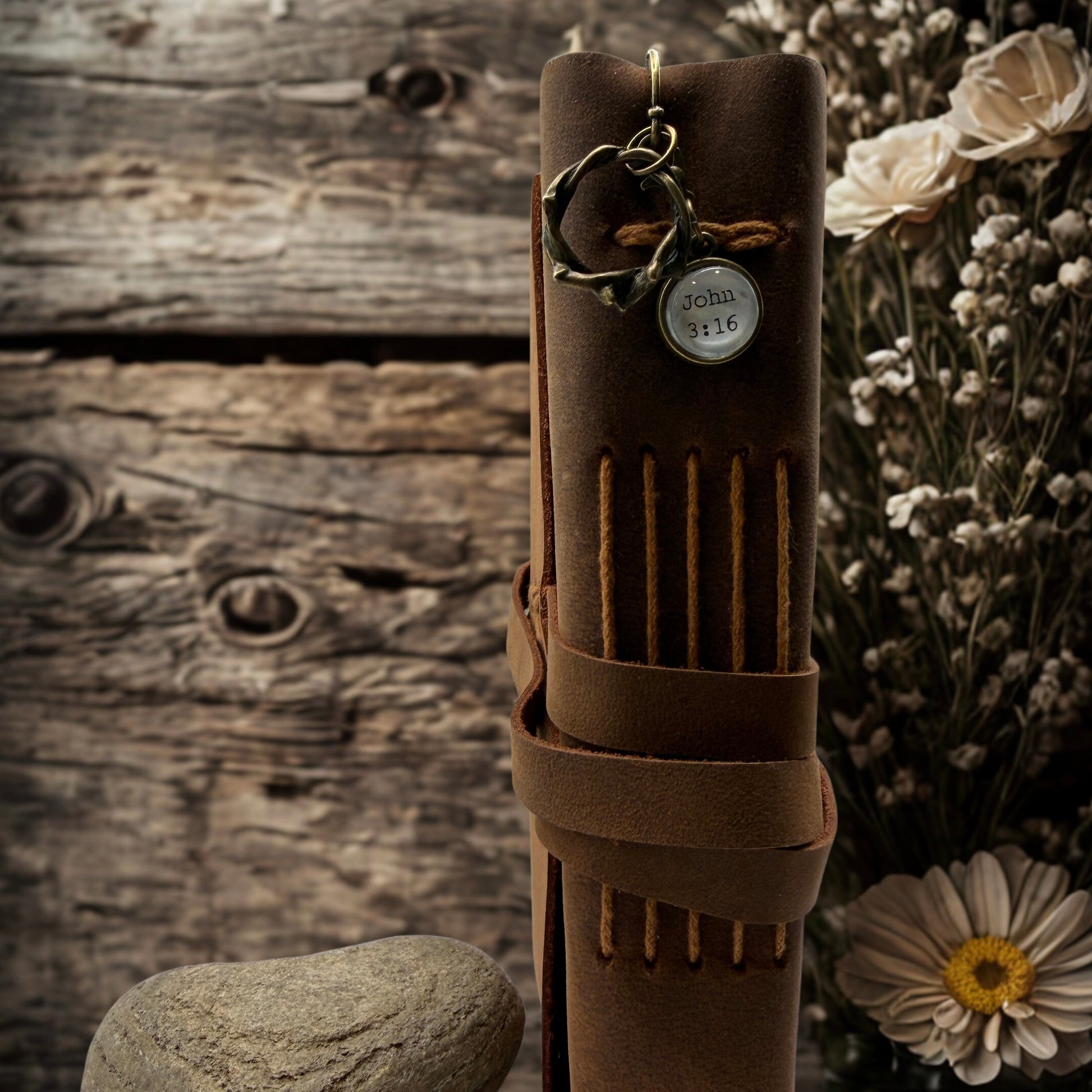 Brown leather quiver with archery accessories on a rustic wooden background