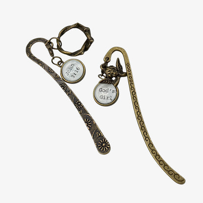 Two bronze bookmarks with circular charms on a white background