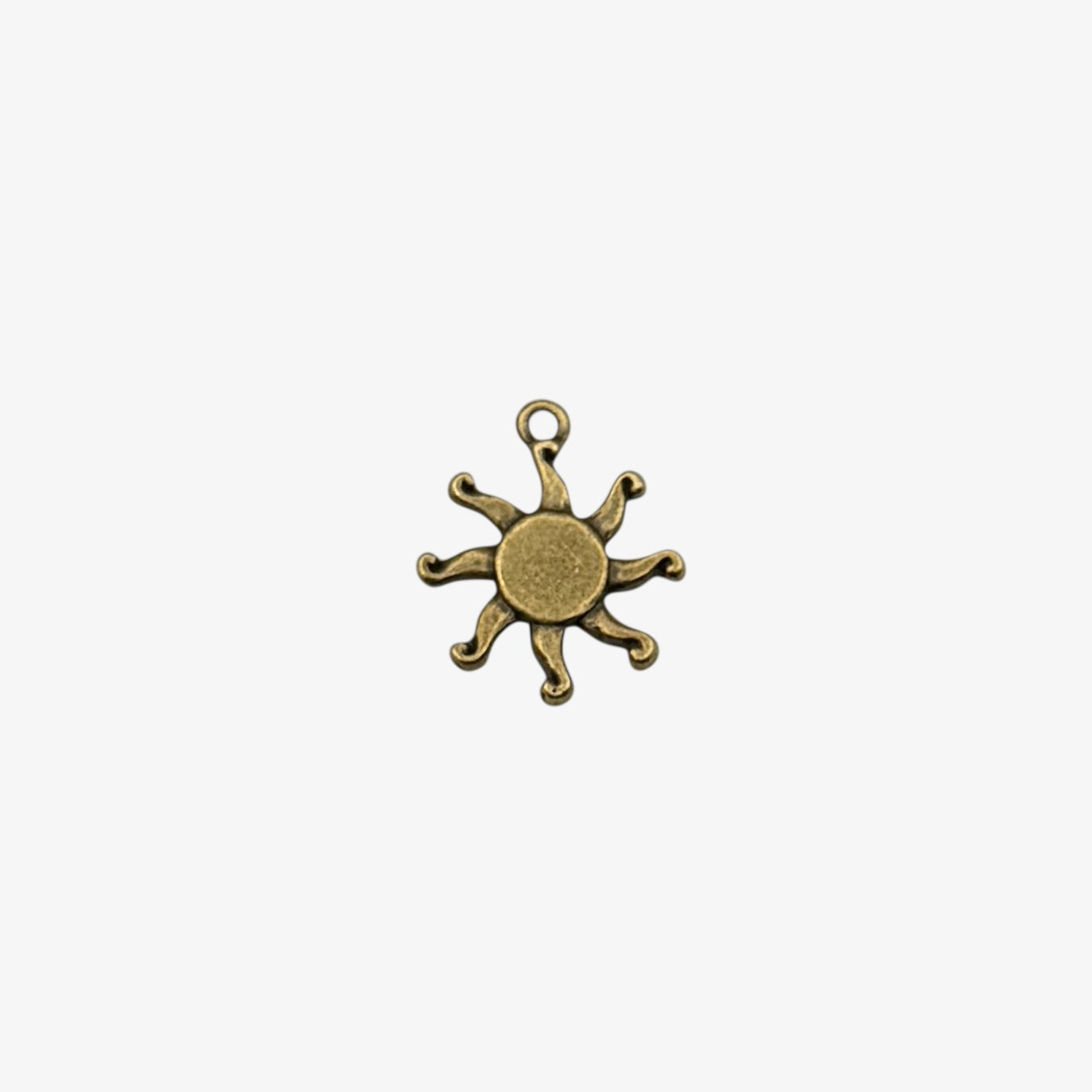 Bronze sun-shaped pendant on a white background