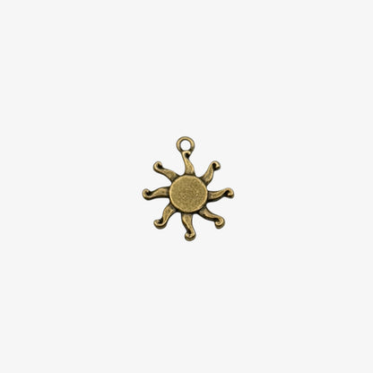 Bronze sun-shaped pendant on a white background