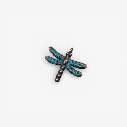 Dragonfly-shaped pendant with blue and bronze colors on a white background