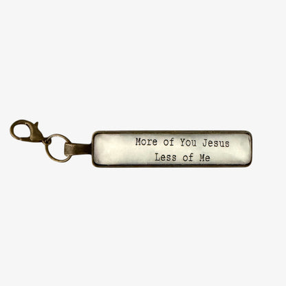 Keychain with engraved text 'More of You Jesus Less of Me' on a white background