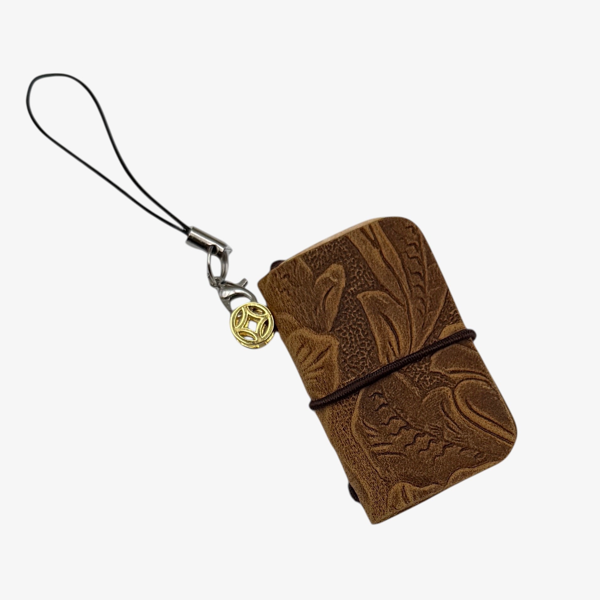 Brown leather wallet with embossed design and keychain on a white background