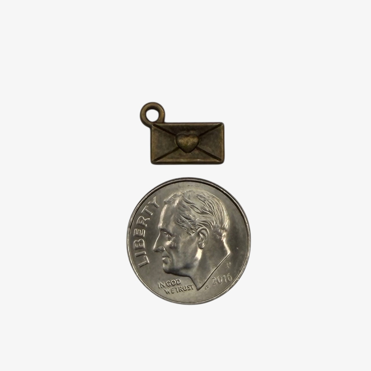 Small bronze pendant with a coin charm on a white background