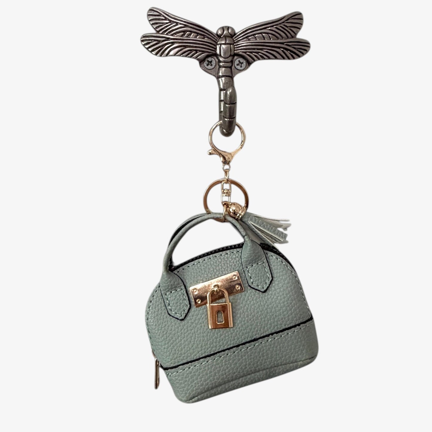 Keychain with a miniature handbag and dragonfly design on a white background