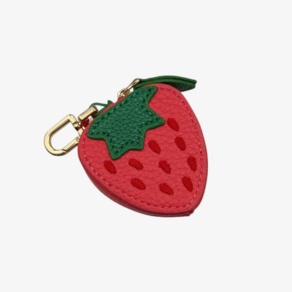 Strawberry-shaped keychain with gold clasp on a white background