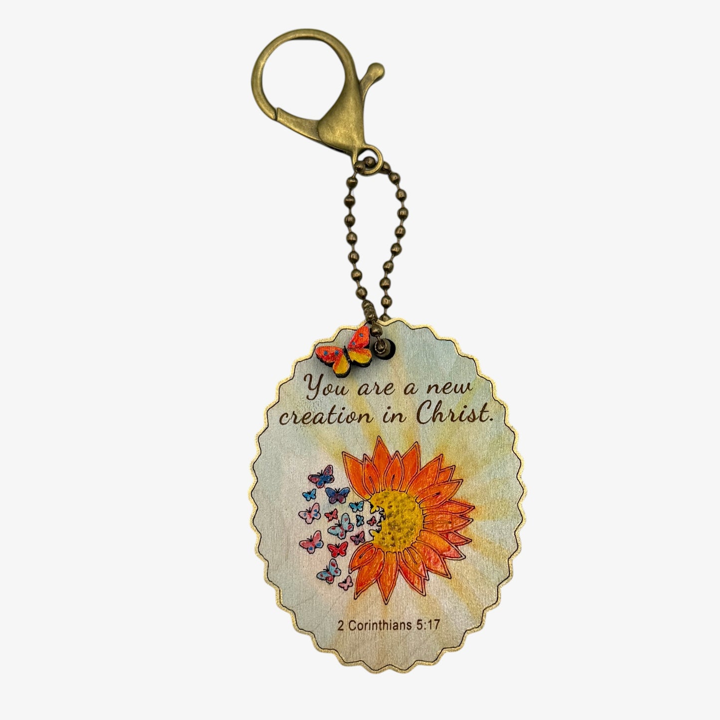 Keychain with sunflower design and inspirational quote on a white background