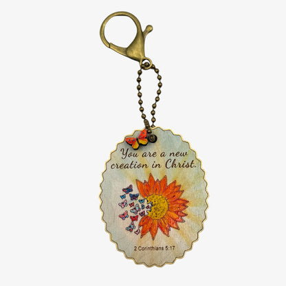 Keychain with sunflower design and inspirational quote on a white background