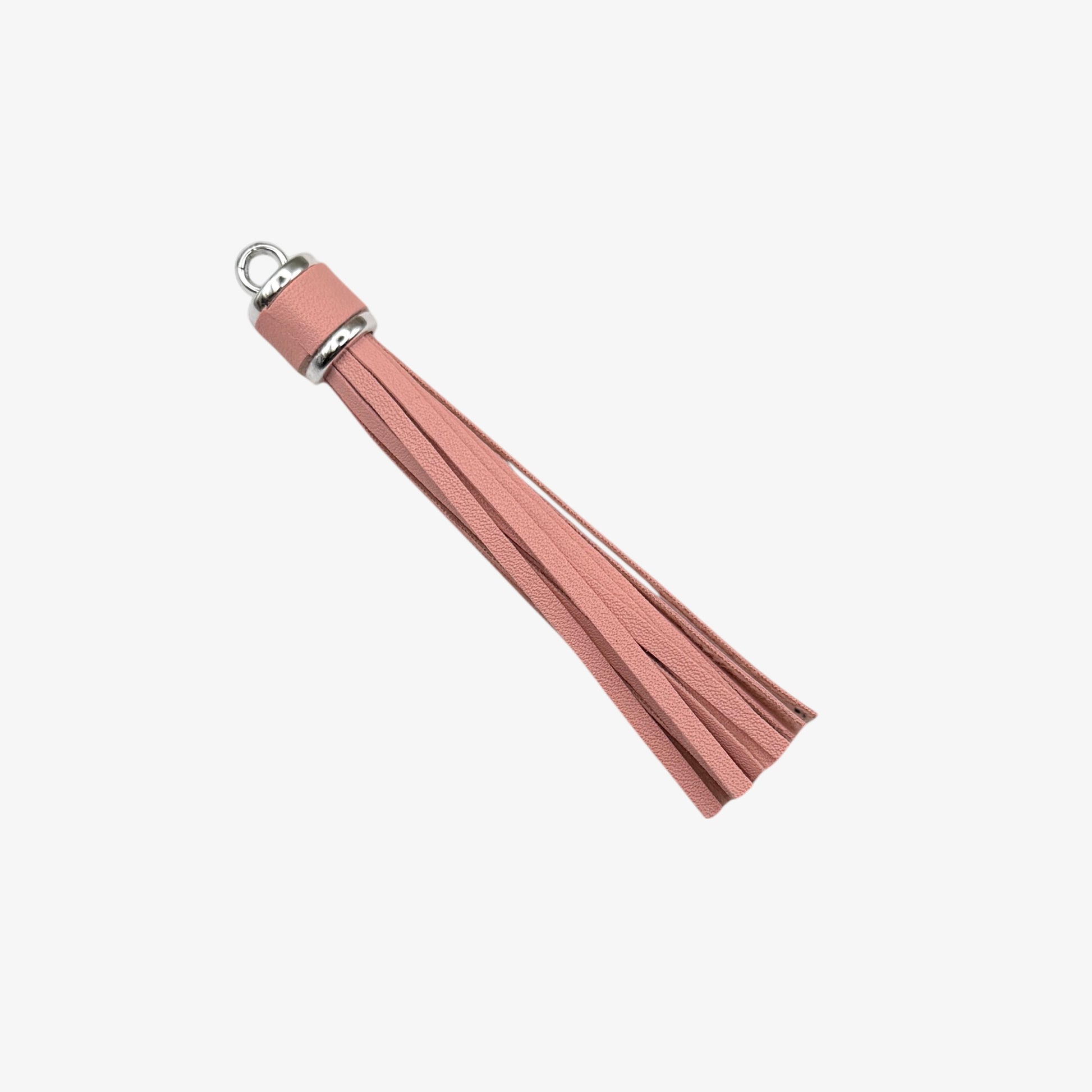 Pink tassel with a silver ring on a white background