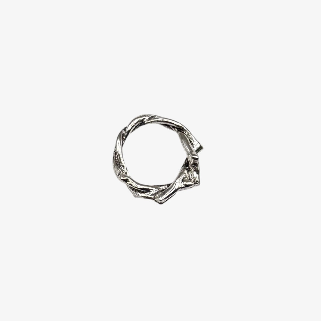 Silver ring with a twisted design on a white background