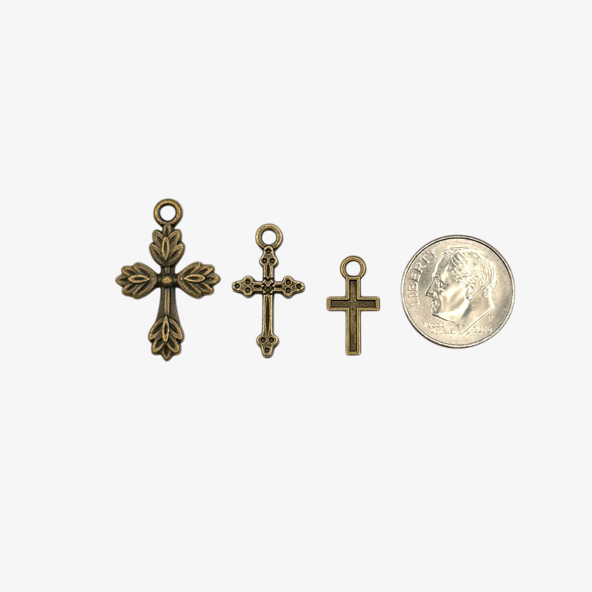 Three small bronze cross pendants 