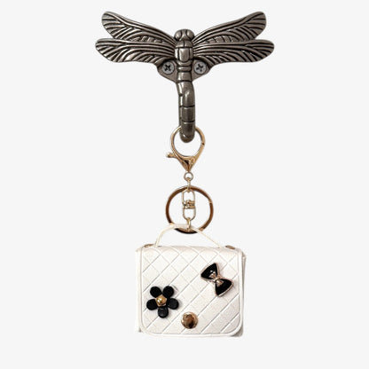 Keychain with dragonfly design and small pouch on a white background