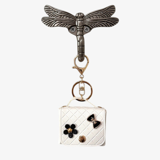 Keychain with dragonfly design and small pouch on a white background