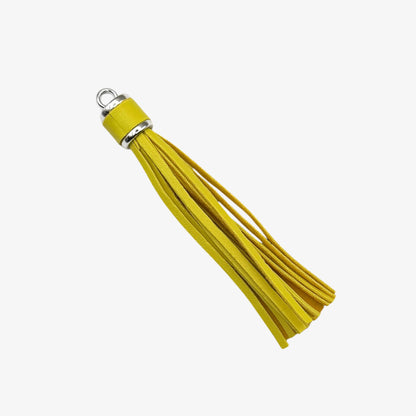 Yellow tassel with a silver ring on a white background
